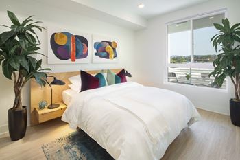 a bedroom with a large bed and a window